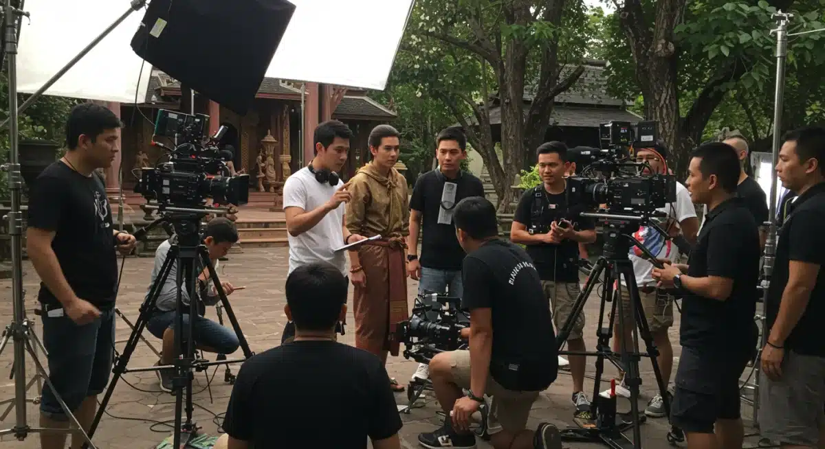 Behind-the-scenes production of a Thai drama, director with actors